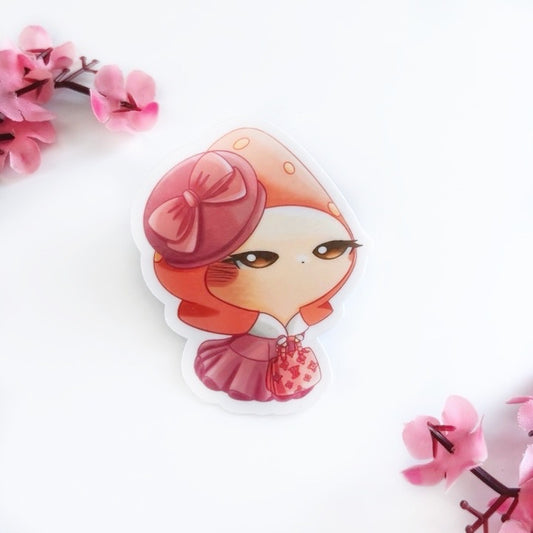 A bunny wearing a pink, strawberry hat wearing a pink, fancy winter dress with fur and a pink beret with a bow holding a Louis Vuitton pink bag on a white surface with pink flowers.